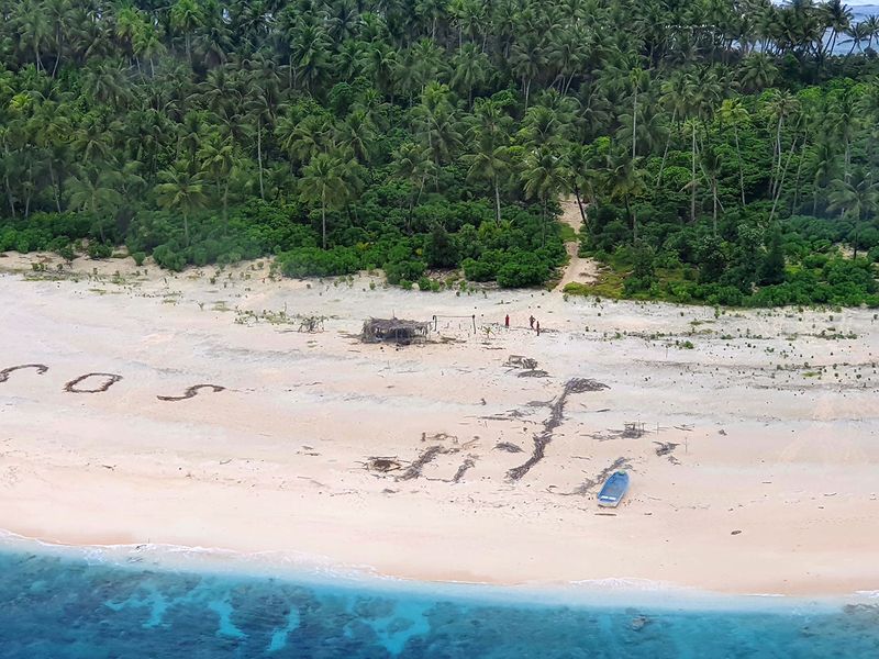 Miracle  rescue  for three  men  from tiny Pacific island who made Sand SOS signal